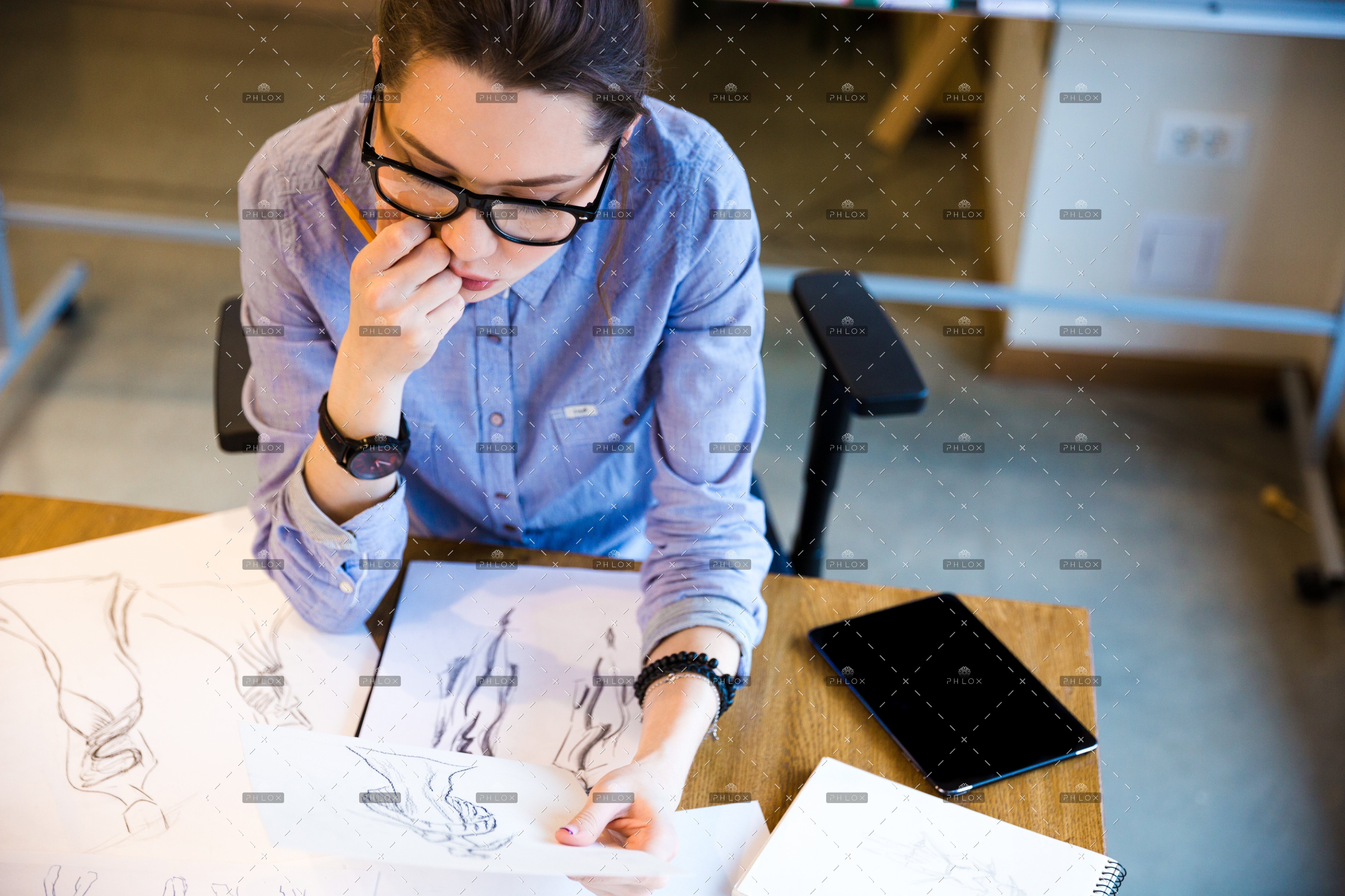 demo-attachment-168-pensive-woman-fashion-designer-sitting-and-PHGZYEM